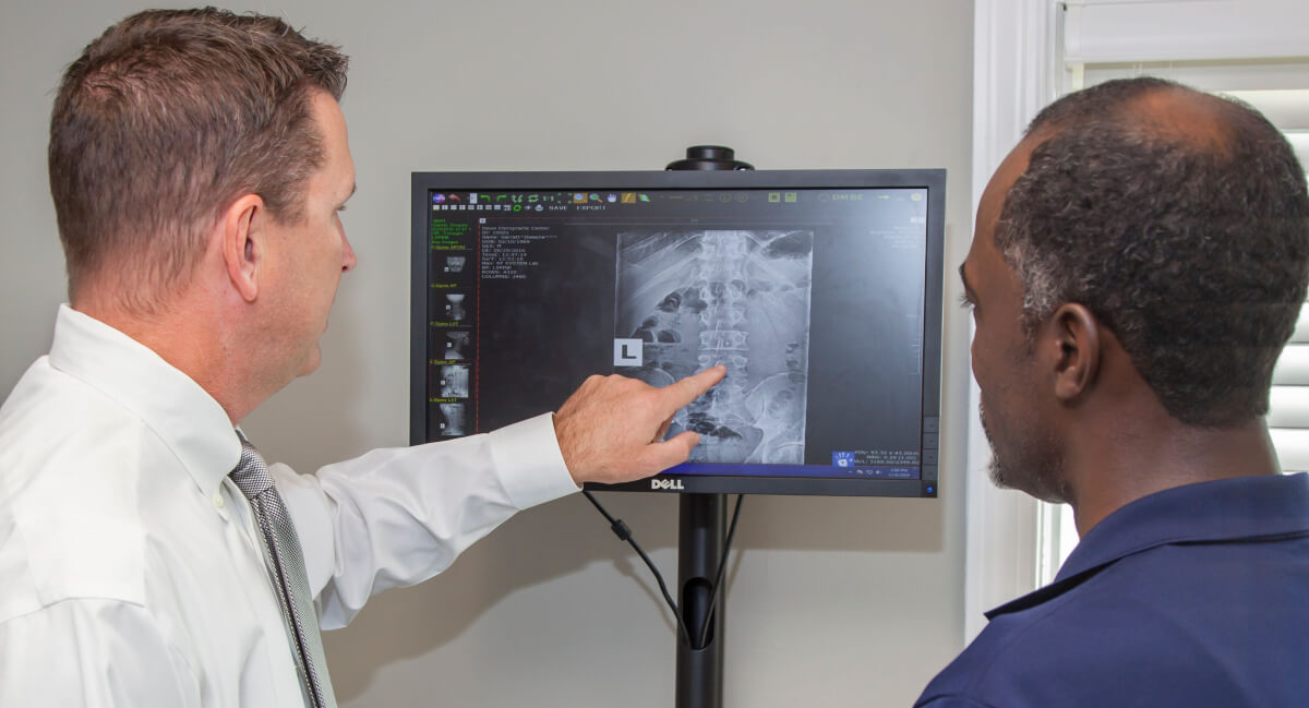 Dr. Gary discussing x-ray results with patient