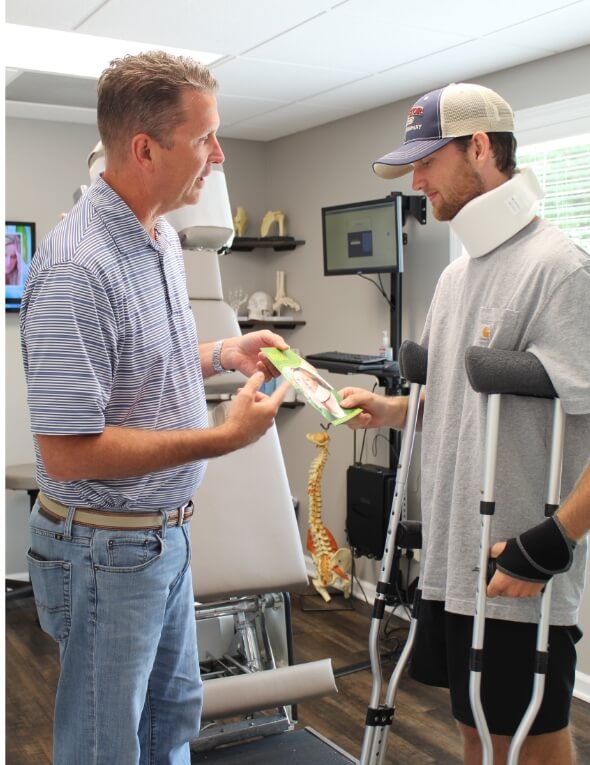 Chiropractor talking to patient