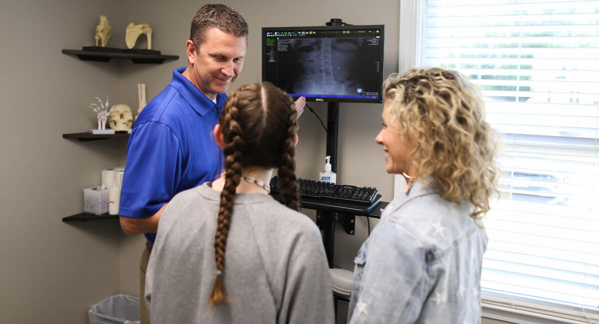 Peachtree City chiropractor discussing x-rays with patients