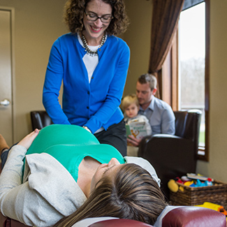 Dr. Cindy adjusting pregnant mom