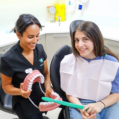 Oral Health Therapist, Monica Ramzy with patient (oral hygiene)