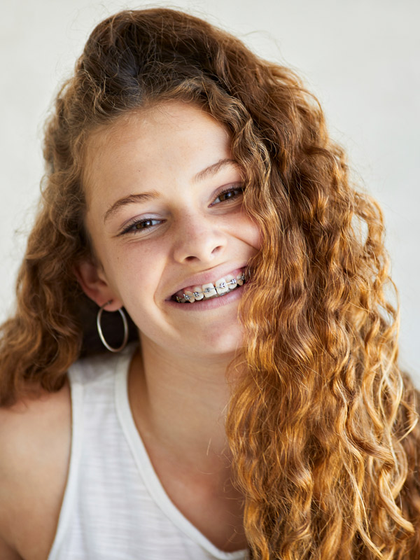 girl smiling with metal braces