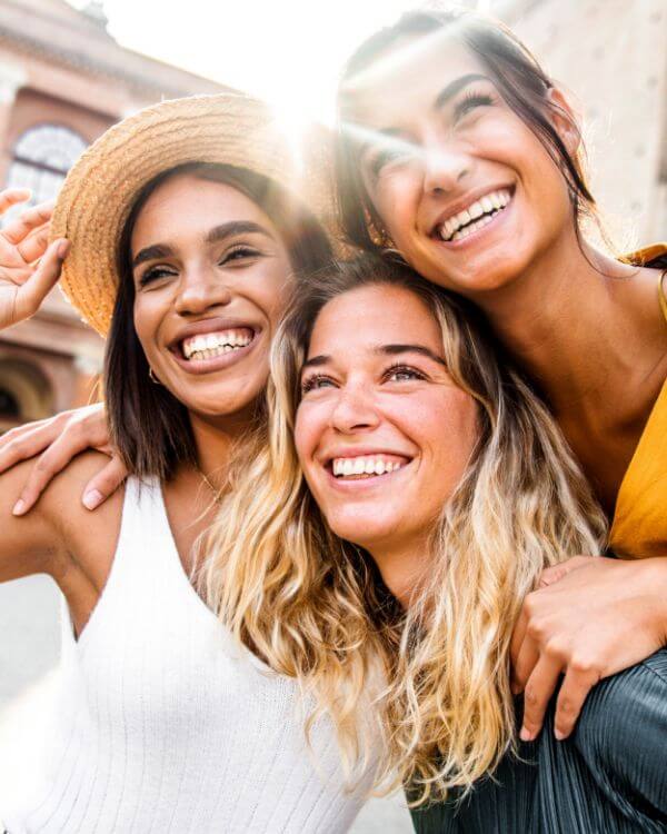 three smiling young women in close-up