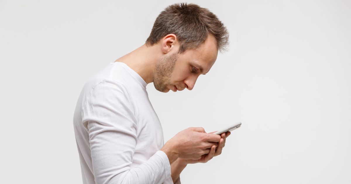 man using phone bad posture