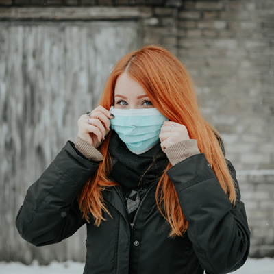 woman covering mouth with mask