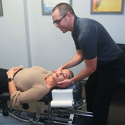 Patient's neck being adjusted