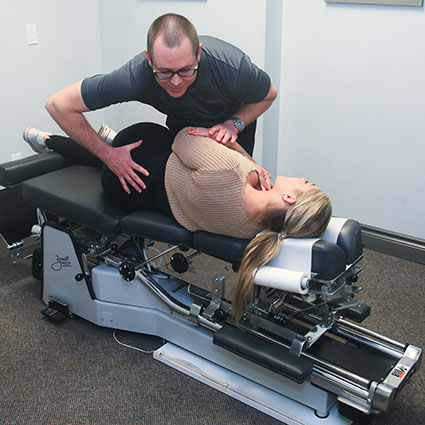 Dr Ryan adjusting a patient using a twisting method