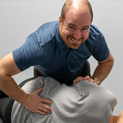 Dr Aaron adjusting woman's back