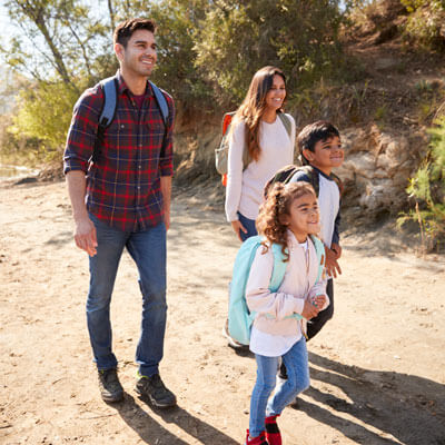 family hiking near a lake