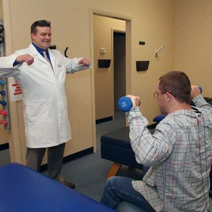 Cincinnati chiropractor Dr John showing patient exercises