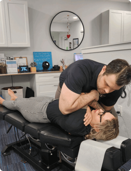 Coastal Chiropractic Chiropractor doing back adjustment