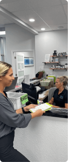 patient completing paperwork at Coastal Chiropractic