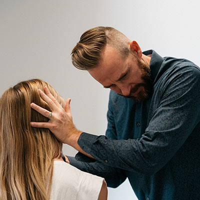 Dr. May adjusting a patient's neck