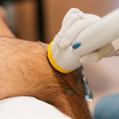 patient getting softwave therapy on their knee