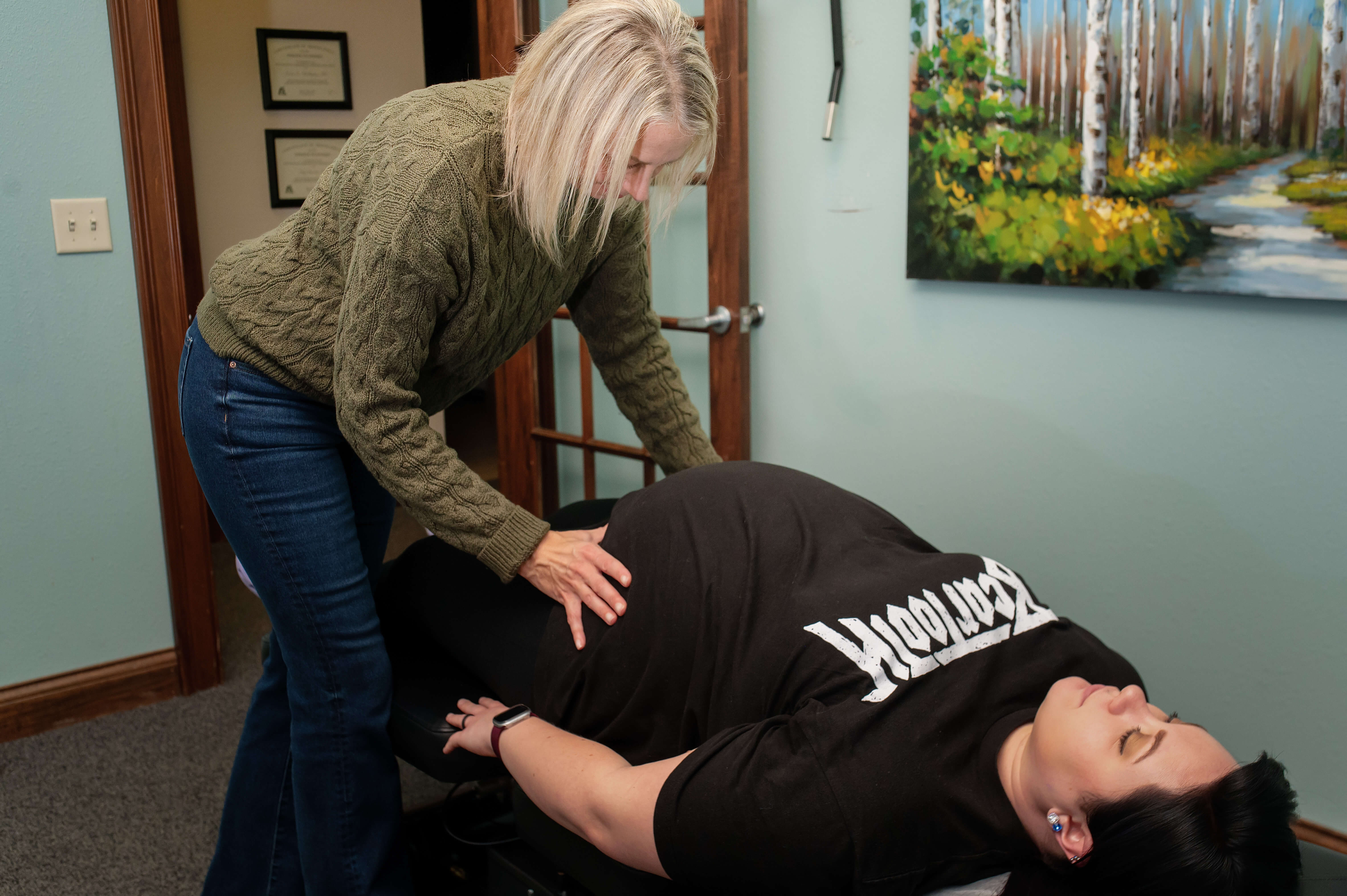 Prenatal chiropractor in Kenosha WI performing a gentle adjustment on a pregnant patient at Absolute Chiropractic + Wellness
