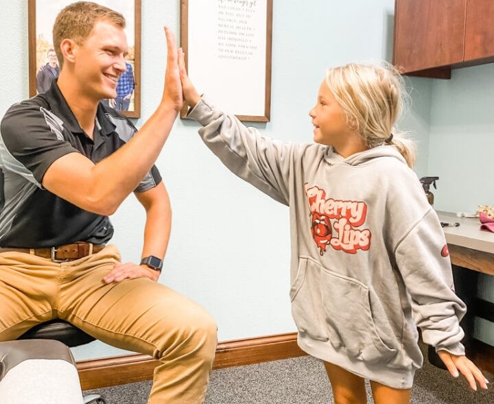 Doctor giving high five to kid patient