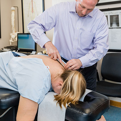 Dr. Brown using tool on patient