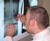 Dr. Ryan examining x-rays taken in his office..