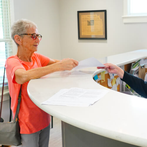 Edmonton patient checking in at reception desk