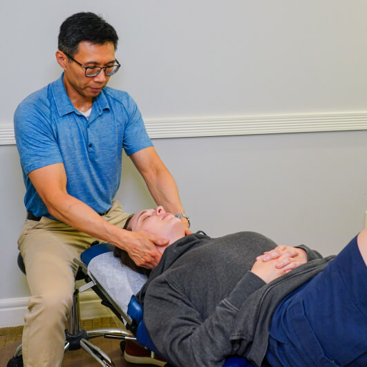 Dr. Kenny massaging patient