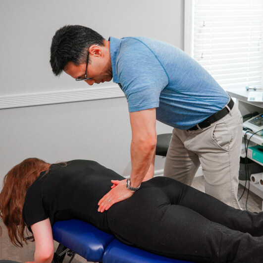 Dr. Kenny adjusting patient back
