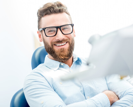 Male patient sitting on dental chair