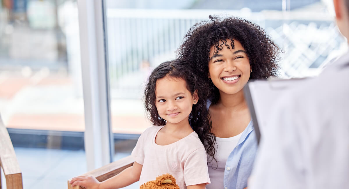 Mom and young daughter sitting in waiting room