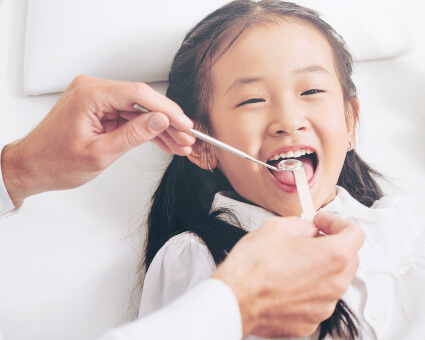 Pediatric patient receiving a dental checkup