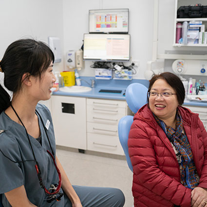 dentist and patient smiling and talking