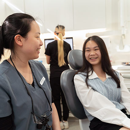 Dentist and patient smiling