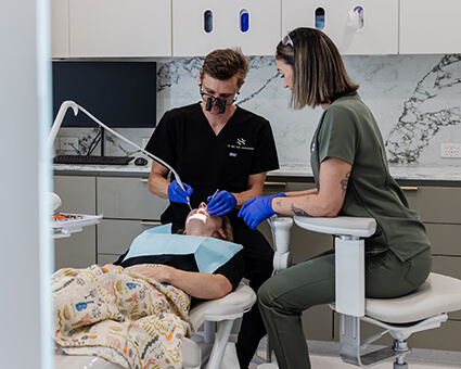 Dentist working in patient's mouth