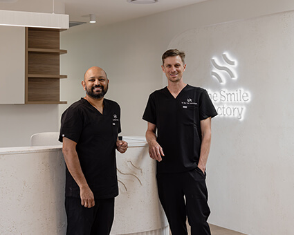 Two dentists at front desk