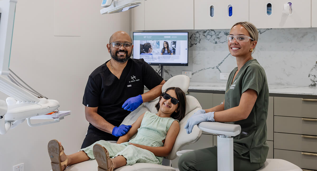 Dr Hitesh with young girl and assistant