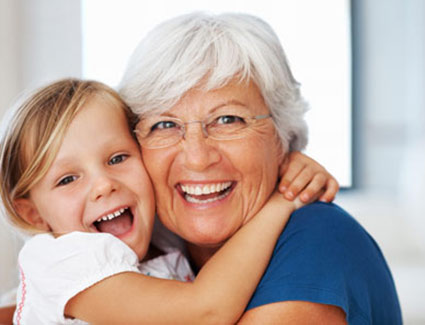 Girl hugging grandma and smiling