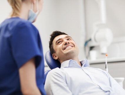 Smiling man sitting on dental chair