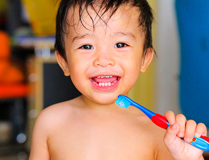 small boy brushing teeth