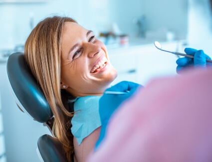 Female patient smiling in dental chair