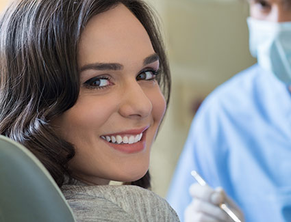 person smiling over their shoulder