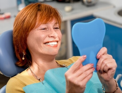 Smiling lady looking at mirror