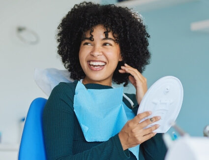 Woman smiling in a dentists chair