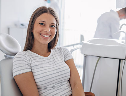 woman smiling in a dentists chair