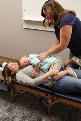 Toddler Adjustment on Mom at Vibrant Family Chiropractic