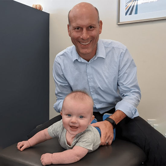 Doctor and baby patient smiling