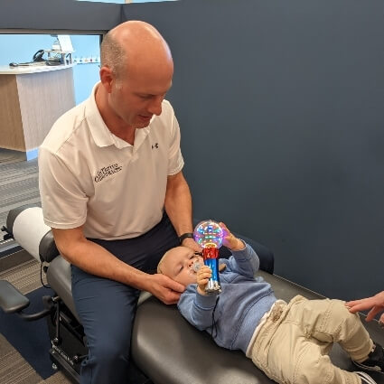 doctor adjusting infants neck