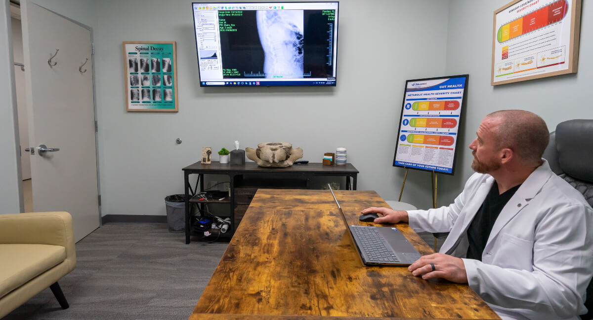 Frisco chiropractor analyzing x-rays