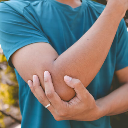 man holding elbow