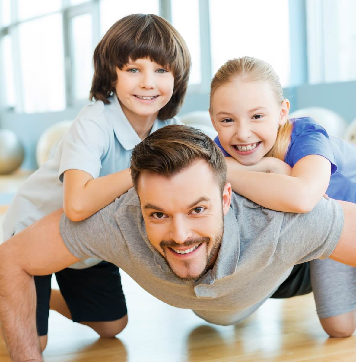 dad and 2 kids smiling