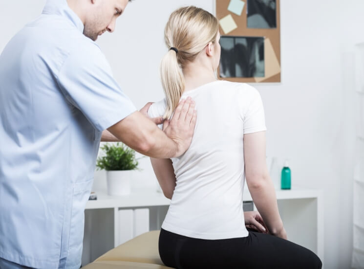 woman having back adjusted