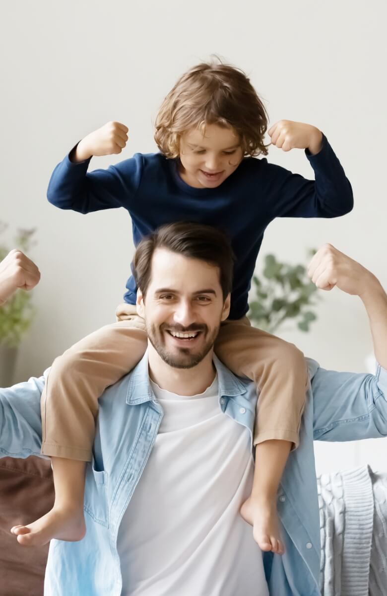 Dad and young son flexing their muscles