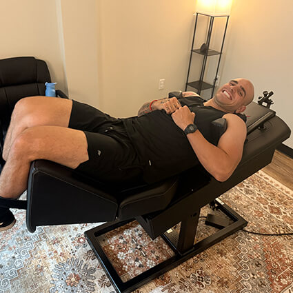 Patient on spinal decompression bed
